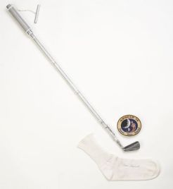 The Moon Club, a specially crafted 6-iron club head, weighing 16.5 ounces, carried by Alan Shepard onboard the Apollo 14 mission to the moon, alongside the sock he used to sneak the club head onboard, now at the USGA Headquarters in Far Hills, NJ.